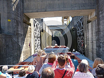 passengers inside the boat making a tourist circuit along the Douro river at the moment they are in the lift system through locks. Editorial Stock Photo