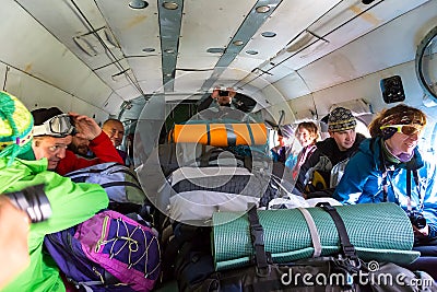 Passengers Inside Cargo Helicopter with Many Backpacks Stock Photo