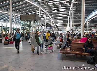 Passengers inside large modern railway terminal concourse Editorial Stock Photo