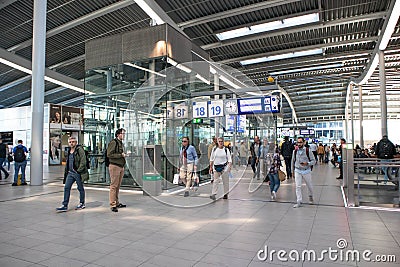 Passengers inside large modern railway terminal concourse Editorial Stock Photo