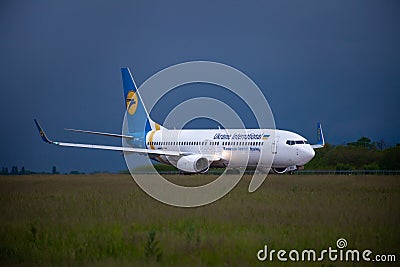 Passengers plane Boeing 737-900ER on the Boryspil airport apron runway. Ukraine International Airlines planes. Editorial Stock Photo