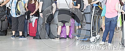 Passengers in row waiting check-in counters at airport at Paris, France Stock Photo