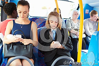 Passengers Sitting On Bus Sending Text Messages Stock Photo