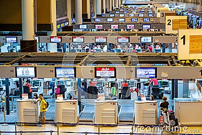 Passengers wait in line to check in their flight at Don Muang International Airport check in counters in Bangkok, Thailand Editorial Stock Photo