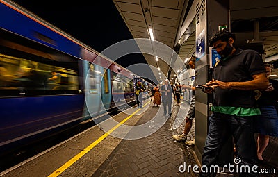 Passengers wait on a platform at London Bridge railway station, London UK Editorial Stock Photo
