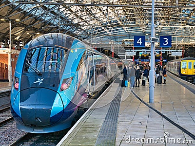 Passengers wait to board a TransPennine Express at Lime Street Station in Liverpool, UK. Editorial Stock Photo