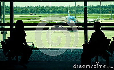 Passengers waiting at departure gate for boarding airplane Editorial Stock Photo