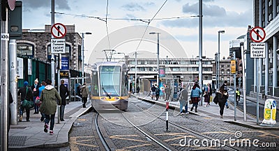 Passengers waiting for an electric tram in Dublin, Ireland Editorial Stock Photo