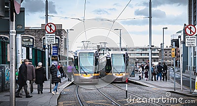 Passengers waiting for an electric tram in Dublin, Ireland Editorial Stock Photo