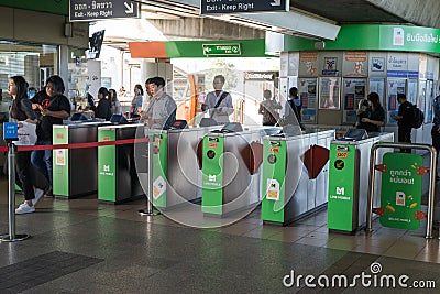 BANGKOK, THAILAND - 5 JUNE 2018: Passengers and security at entry and exit gate with key card access control into BTS Sky train Editorial Stock Photo