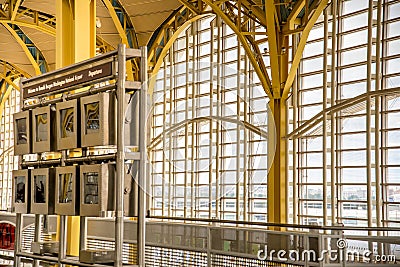 Passengers walking through a bright airport Editorial Stock Photo