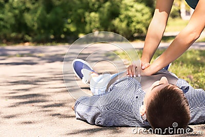 Passerby performing CPR on unconscious man Stock Photo