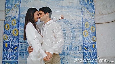 Passionate couple dancing at azulejo place closeup. Pair holding hands embracing Stock Photo
