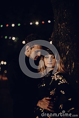 Passionate gypsy bride and groom lovers embracing in evening cit Stock Photo