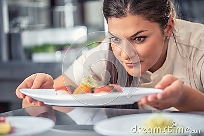 Passionate pro female chef presents her sushi delicacy Stock Photo
