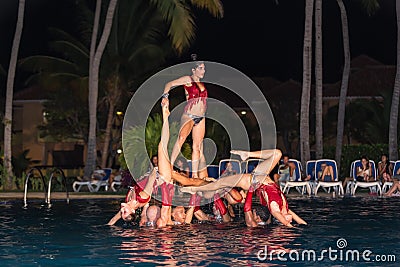 passionate professional Cuban dancers at night swimming pool. Editorial Stock Photo