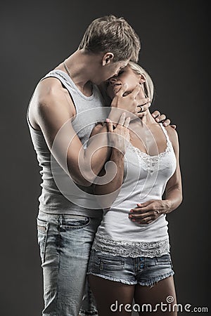 Passionate young couple in love on dark Stock Photo