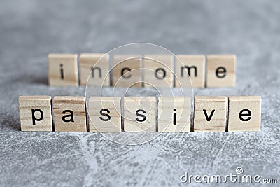 Passive income word written on wood cube Stock Photo