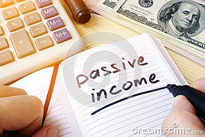 Passive income written in a note. Stock Photo