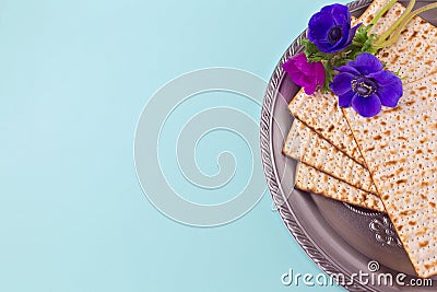 Passover background with matzah, seder plate and spring flower. Flat lay view from above Stock Photo
