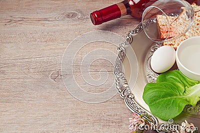Passover (pesah) background with seder plate, matzoh and wine over wooden background Stock Photo
