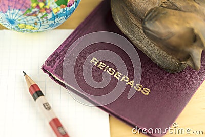 Passport on Desk with Pencil, Paper Pad and Globe Stock Photo