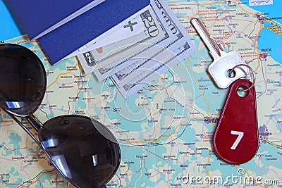 Passports sunglasses money and room key number seven on map. Travel concept Stock Photo