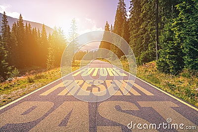 Past, Present, Future concept. Driving on an empty road in the mountains to the Future passing Present and leaving behind the Past Stock Photo