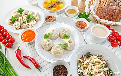 Pasta, bowls of various sauces, vegetables and soup pelmeni for lunch Stock Photo