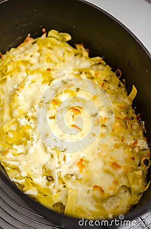 Pasta with cheese and butter in castiron pot Stock Photo