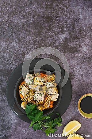 Pasta with chicken, pumpkin and pesto Stock Photo