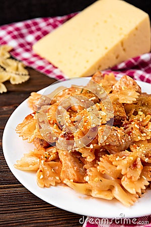 Pasta with chicken, spices and tomato sauce on dark wooden background Stock Photo