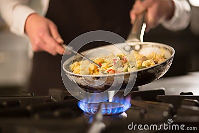 Pasta dish with vegetables on stove Stock Photo