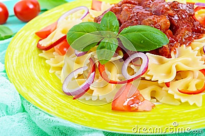 Pasta Farfalle with chicken, tomato, blue onion, sweet pepper and tomato sauce Stock Photo