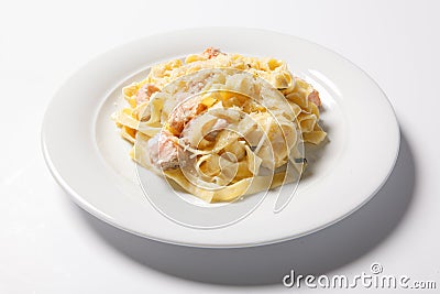 Pasta fettuccine alfredo with chicken, parmesan and parsley on white plate. Italian cuisine. Stock Photo