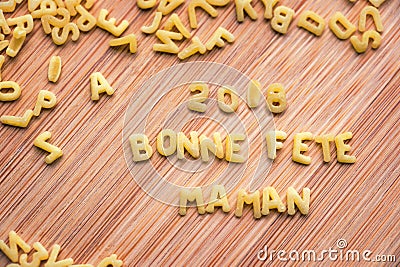 Pasta forming the text 2018 Bonne Fete Maman, meaning Happy Mothers Day in French Stock Photo