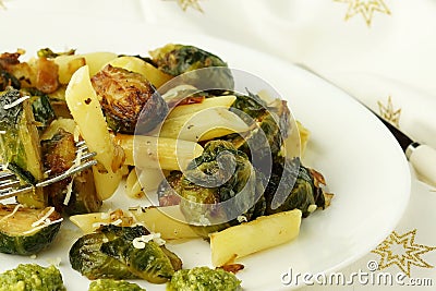 Pasta with green vegetables roasted brussel sprouts and pesto sauce Stock Photo