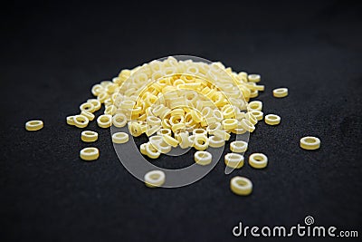 Pasta noodles small ring of raw on a black background Stock Photo