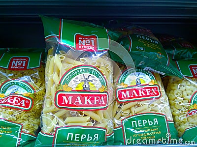 Pasta packaged on supermarket shelf. Price regulation concept. Retail industry. Healthy eating. Store. Fresh food. Discount. Rack. Editorial Stock Photo