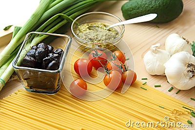 Pasta, pesto, olives and tomatoes Stock Photo