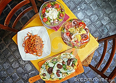 Pasta , pizza , salad and homemade food arrangement in a restaurant Rome Stock Photo