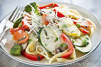 Pasta primavera with fettuccine and garden vegetab Stock Photo