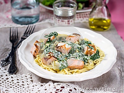 Pasta with salmon and creamy spinach sauce Stock Photo