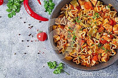 Pasta in the shape of hearts with chicken and tomatoes in tomato sauce. Stock Photo