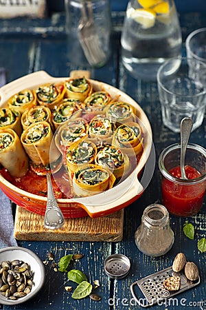 Pasta snails made with lasagne and stuffed with spinach and feta cheese Stock Photo