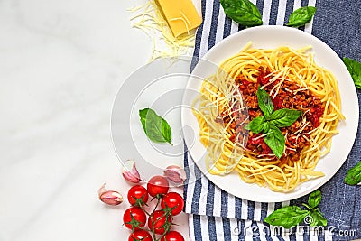 Pasta spaghetti bolognese on a white plate on kitchen towel over white marble table. healthy food. top view Stock Photo