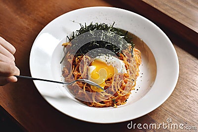 Pasta spicy garlic and mentaiko with soft boiled egg. Stock Photo