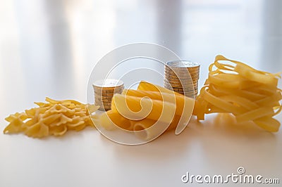 Pasta and stacks of money. Increase in the price of wheat and products. Stock Photo