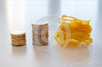 Pasta and stacks of money. Increase in the price of wheat and products. Stock Photo