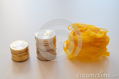 Pasta and stacks of money. Increase in the price of wheat and products. Stock Photo